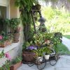 2-Tier Garden Cart Plant Stand with Decorative Wheels and Handle – Black Metal Flower Display Rack